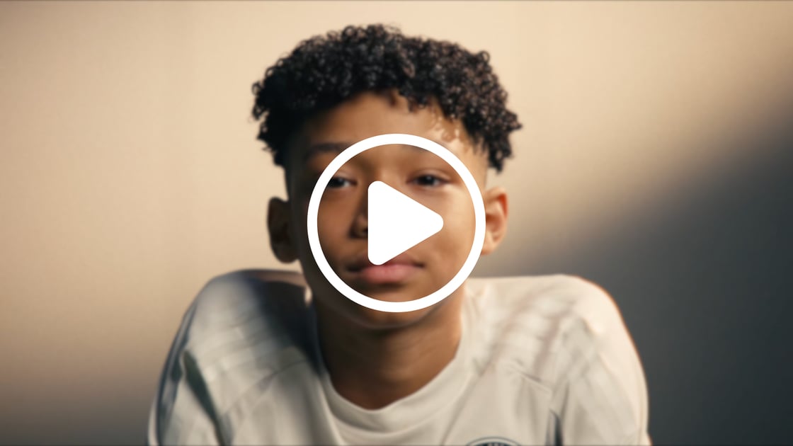 A video still of a child looking directly at camera.