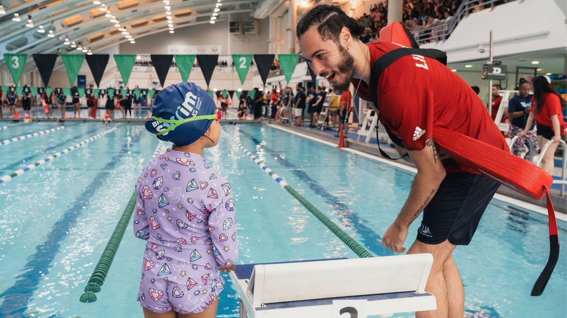 A Big Swim participant talking to an Asphalt Green lifeguard.