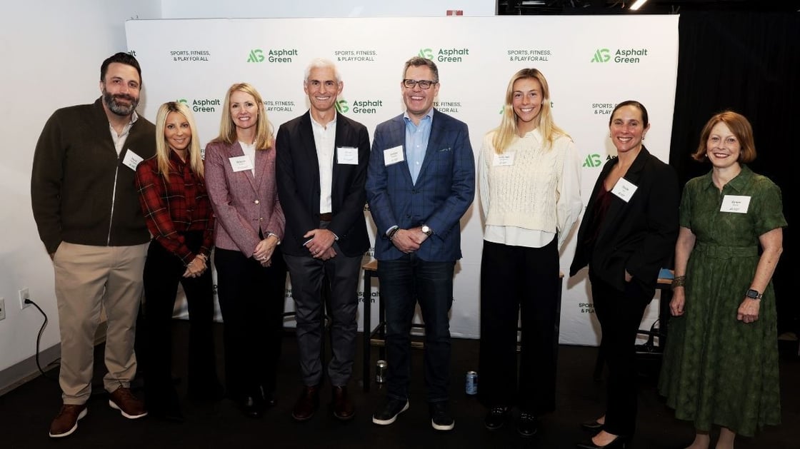 Event panelists, the moderator, Asphalt Green CEO, and Asphalt Green staff gathered for a photo after the panel discussion event at Asphalt Green's Upper East Side campus.