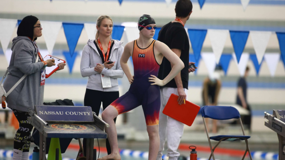AGUA's Ali Wright standing on a pool's starting block