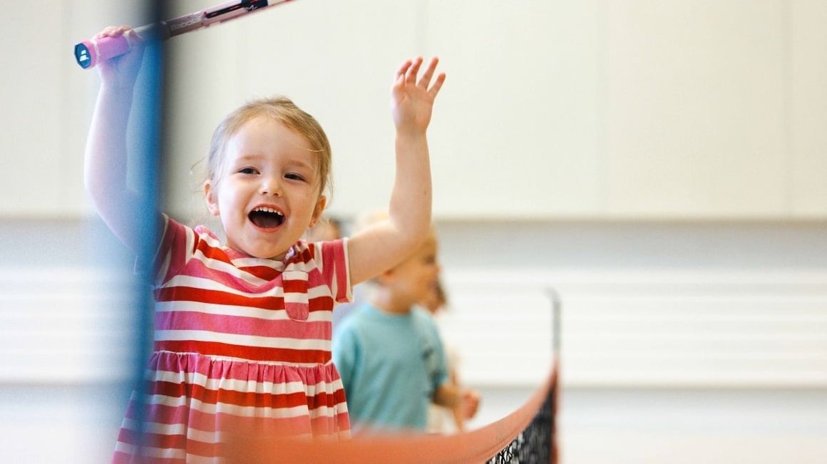 Child playing tennis