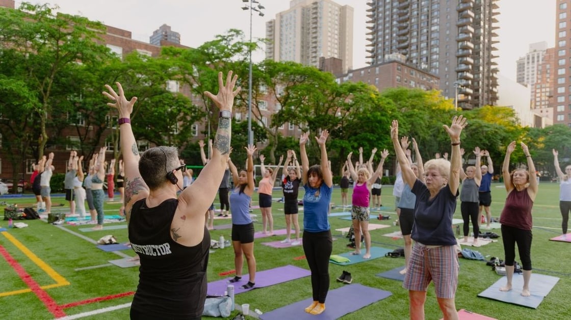A group of people taking an outdoor yoga class