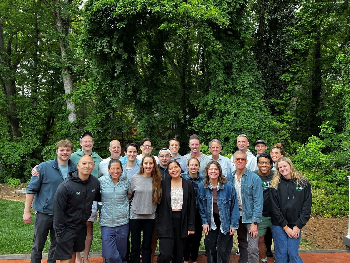 The spring nationals 2026 swimmers posing for a photo with green trees in the background.
